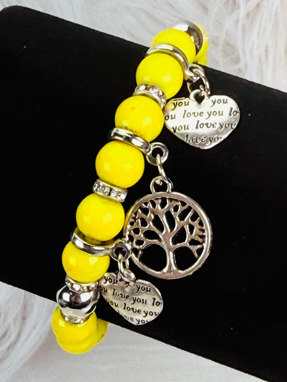 Pretty, silvertone love heart charms yellow stretch bracelet